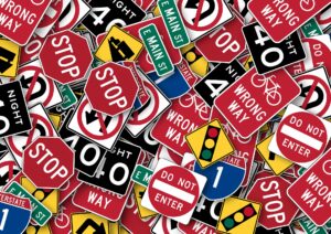 Many traffic signs piled onto each other